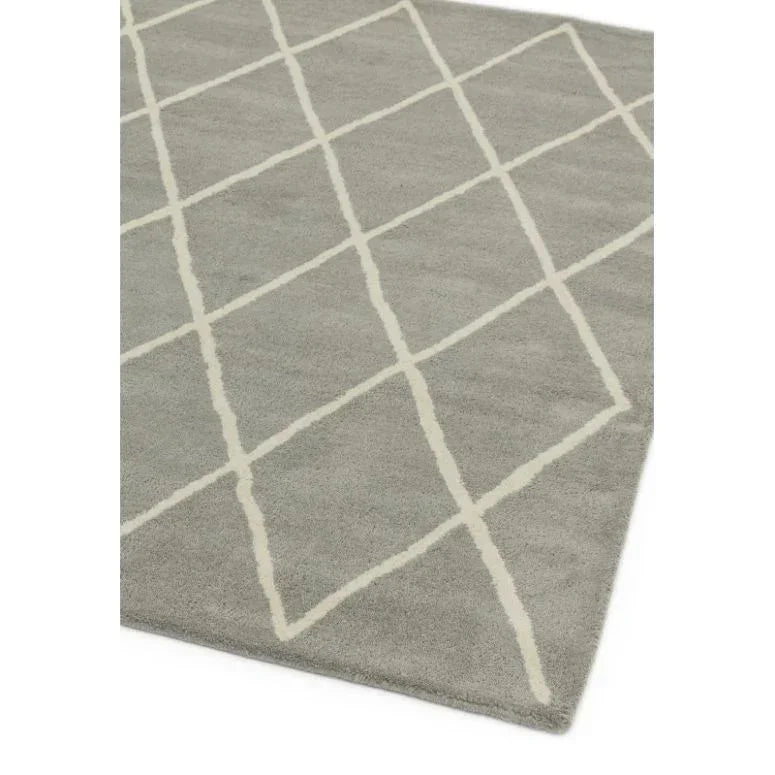 Grey area rug with white geometric diamond pattern, close corner view