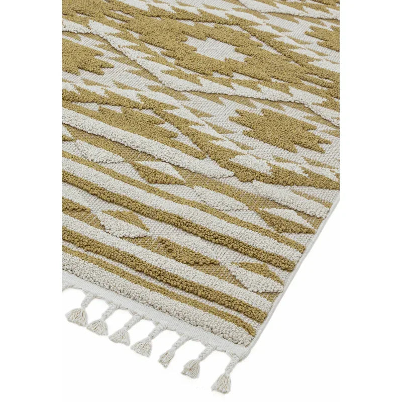 Textured geometric rug in beige and mustard with tassel edge detail