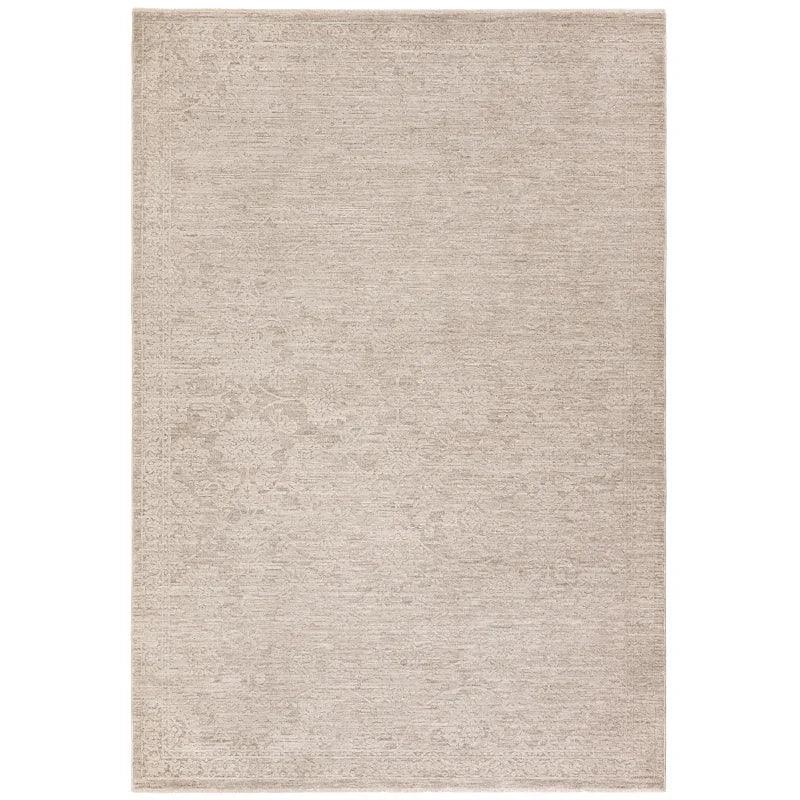 Beige area rug with subtle textured pattern and short pile