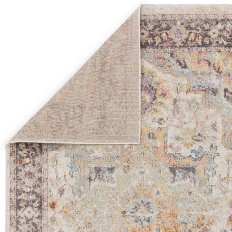 Corner view of multicoloured patterned area rug with detailed border and soft texture