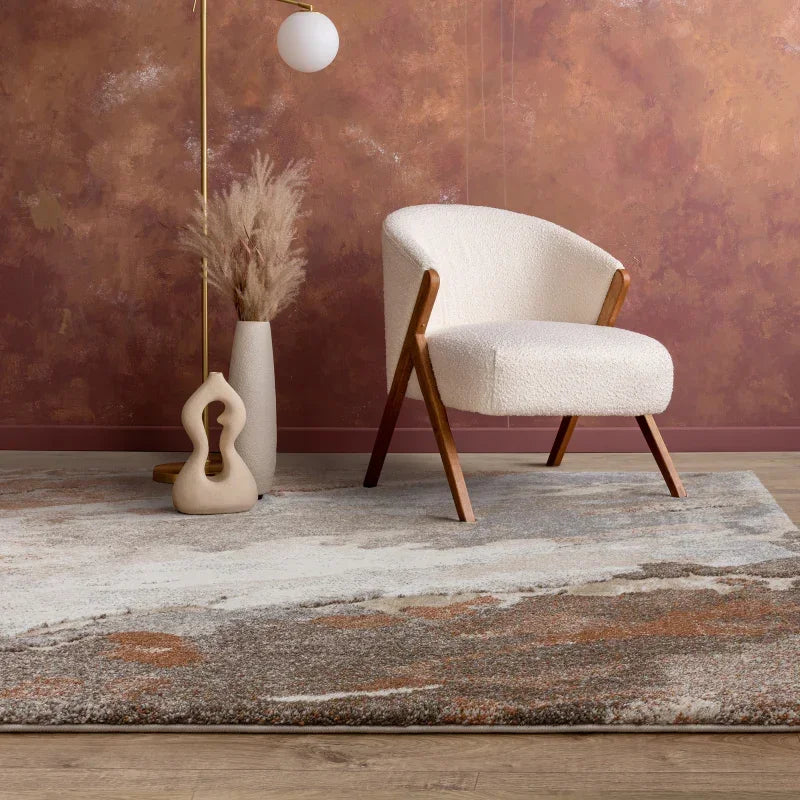 Cream accent chair with wooden legs on modern patterned living room rug
