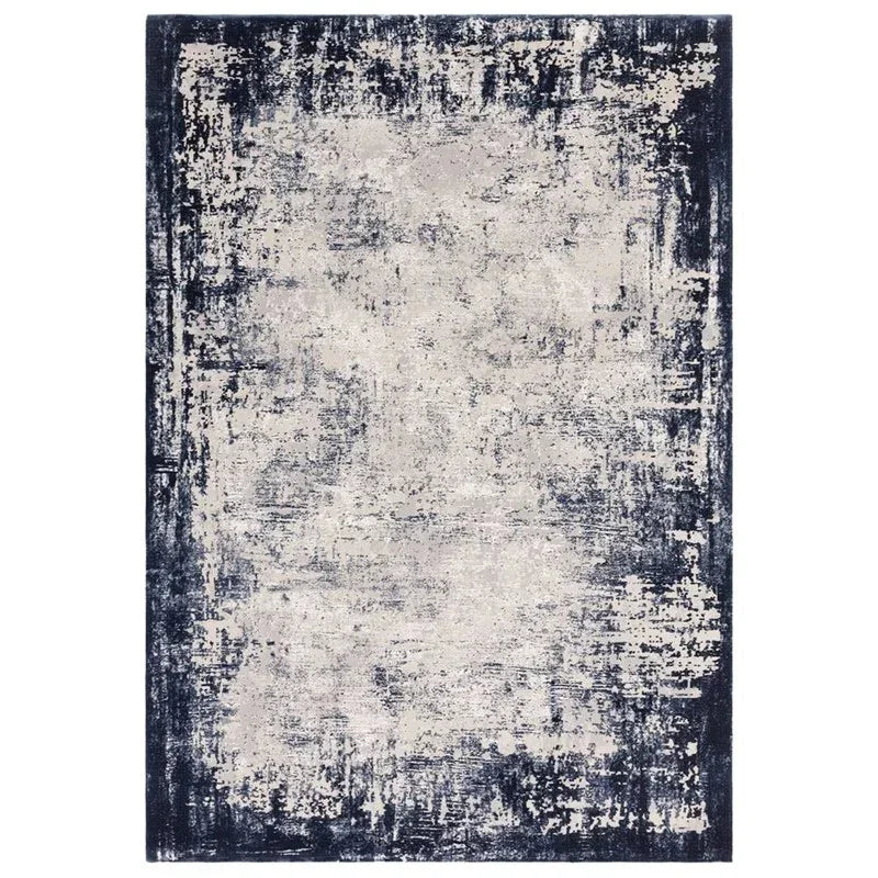 Navy and cream distressed area rug with abstract pattern