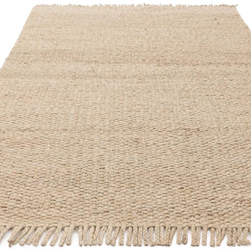 Natural woven jute rug with tasseled edges, textured surface, rectangular shape