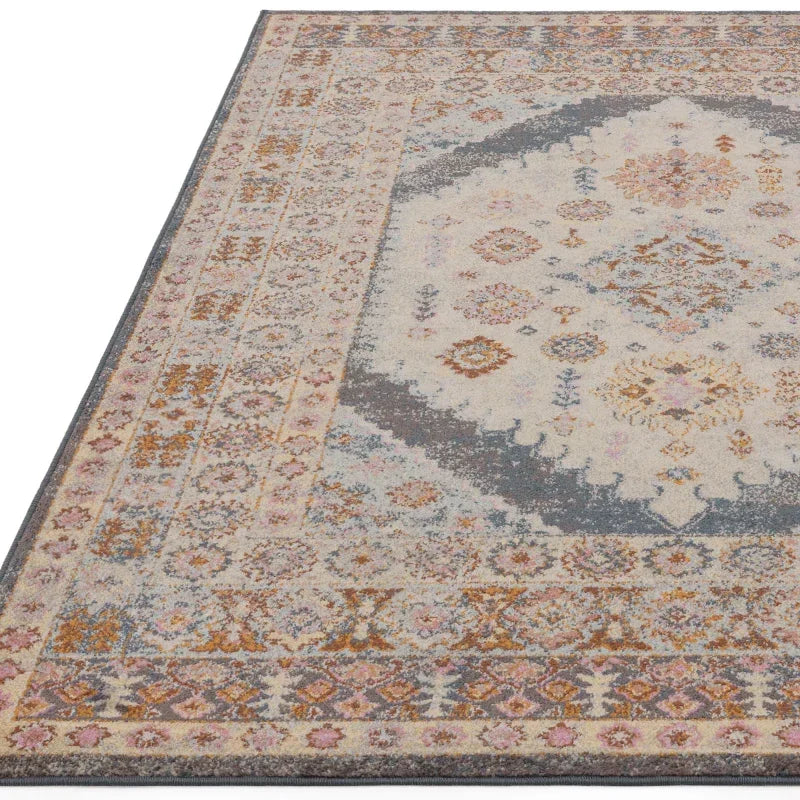 Patterned area rug with cream, grey, and muted gold medallion and border design