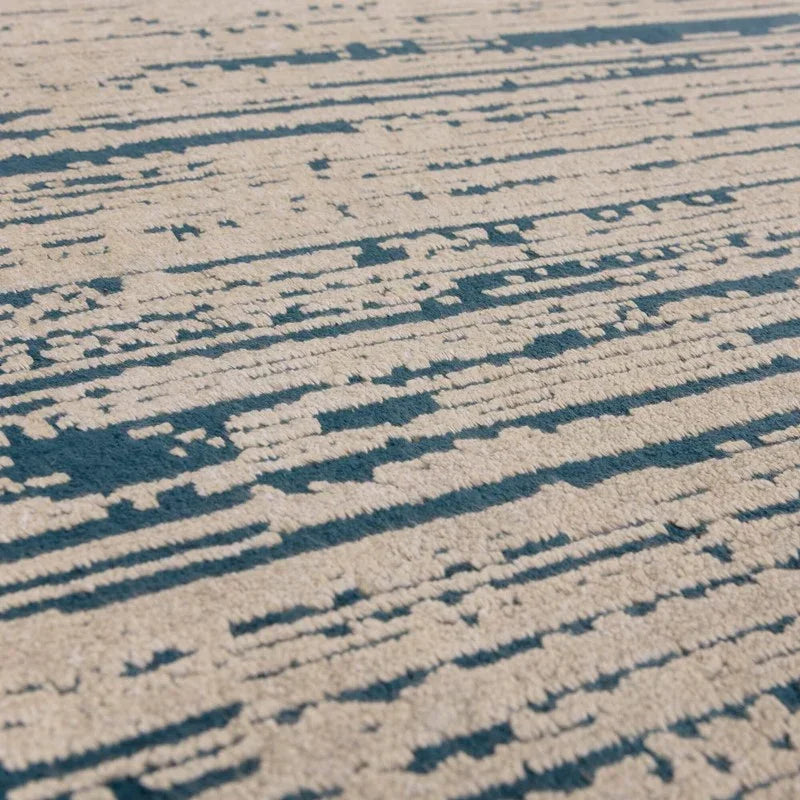 Close up of abstract beige and blue patterned rug texture