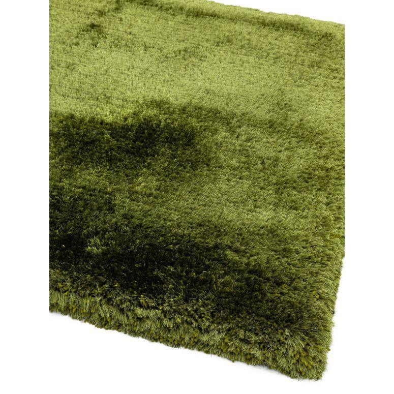 Green shaggy rug with thick pile, close view of soft textured corner