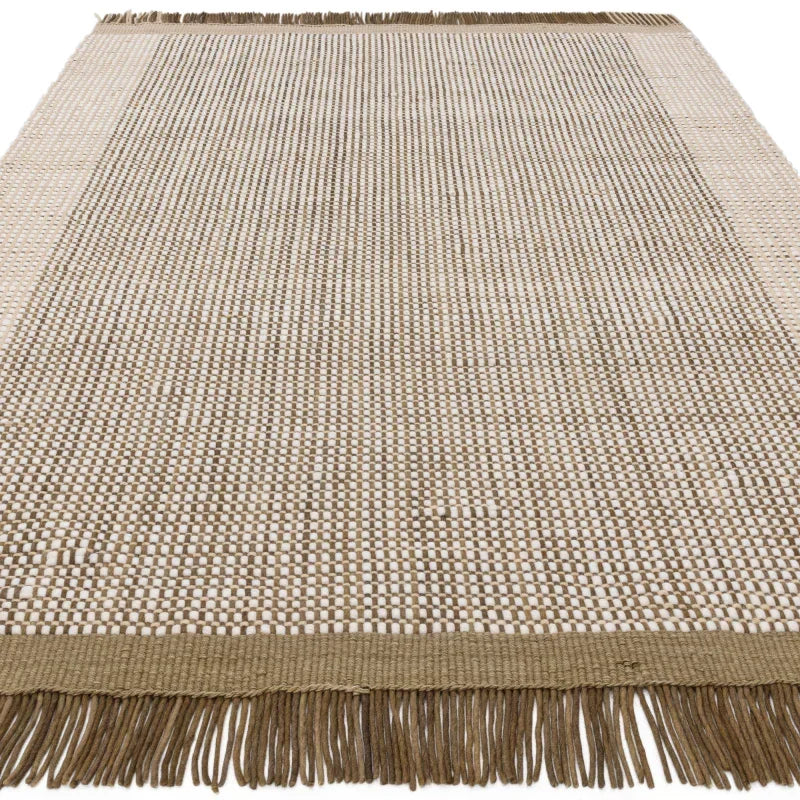 Beige woven rug with frayed edges and textured pattern, viewed from above