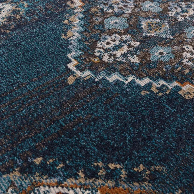 Blue patterned rug with intricate geometric and floral details, close-up texture view