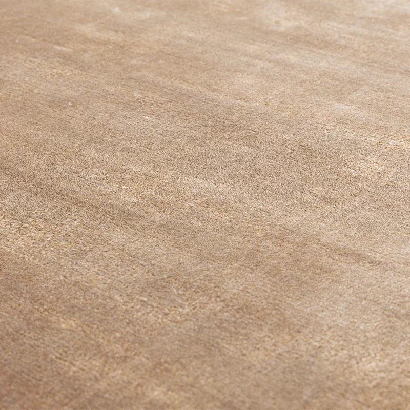 Close-up of beige area rug texture with subtle pattern