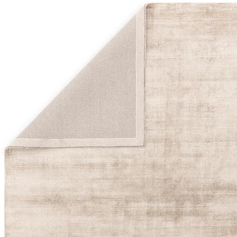 Beige velvet rug close-up showing soft texture and fabric edging