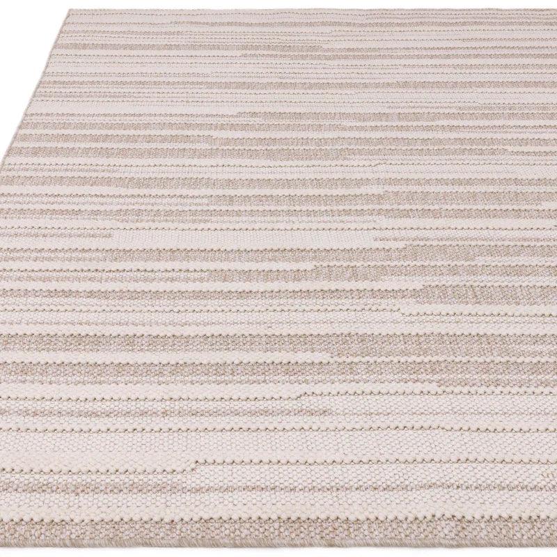 Beige woven rug with textured horizontal stripe pattern, close-up of surface detail