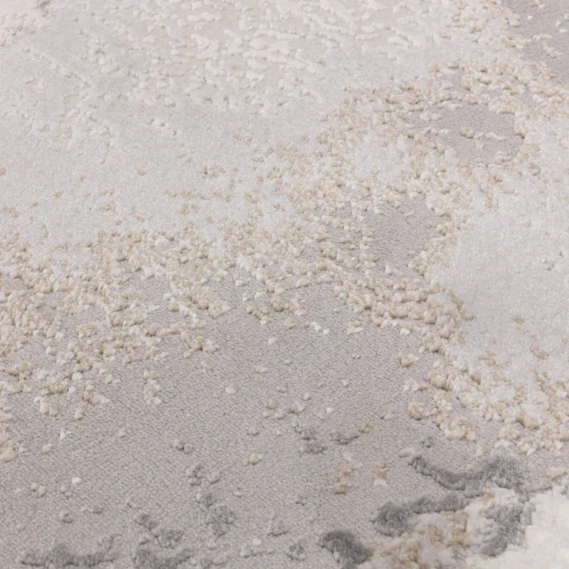 Close-up textured cream and grey area rug with high and low pile detail
