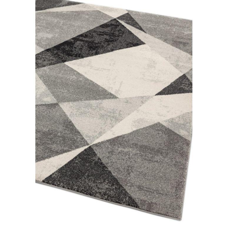 Grey geometric pattern rug with angular shapes and soft texture, corner view