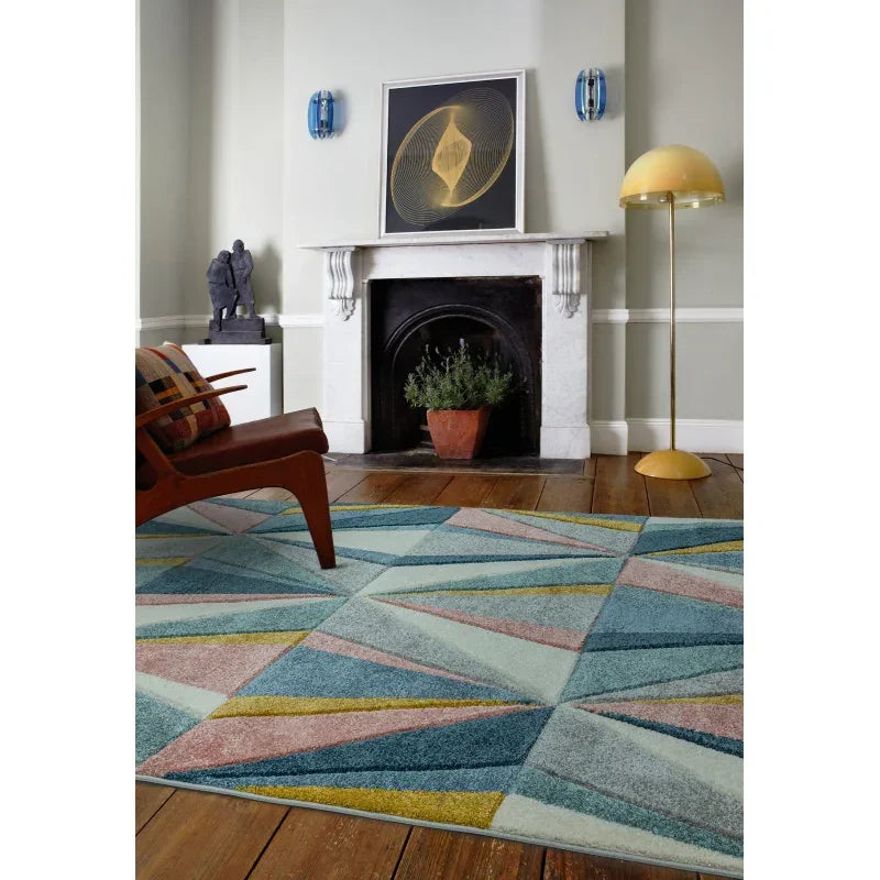 Geometric area rug in blue, yellow, and pink on hardwood floor in modern living room