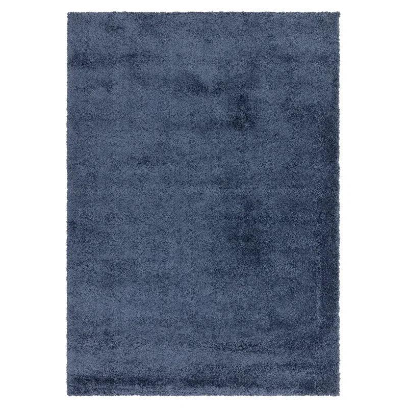 Blue shaggy rug with thick pile texture, shown from above on a white background