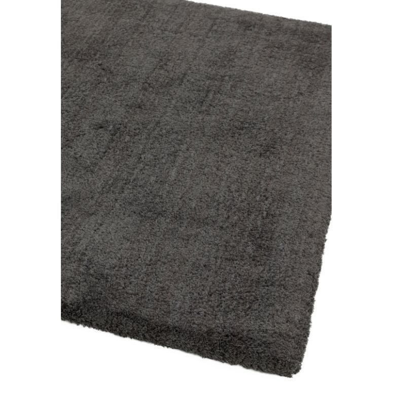 Charcoal grey shaggy rug with thick pile, shown angled to display texture and edge detail
