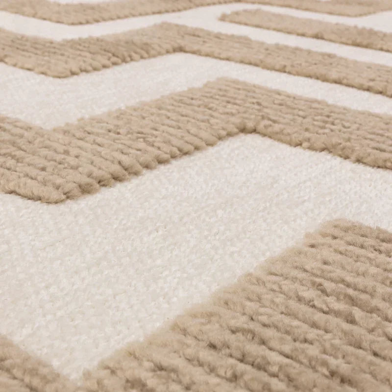 Close up of beige and cream textured wool rug with geometric pattern