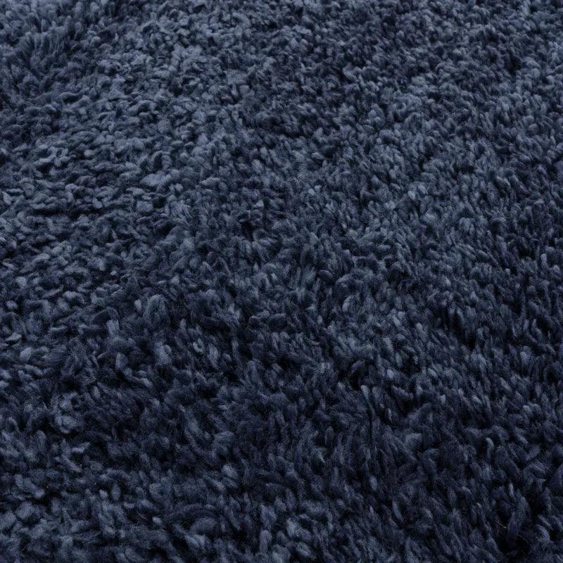 close-up of deep blue shaggy rug texture with soft pile