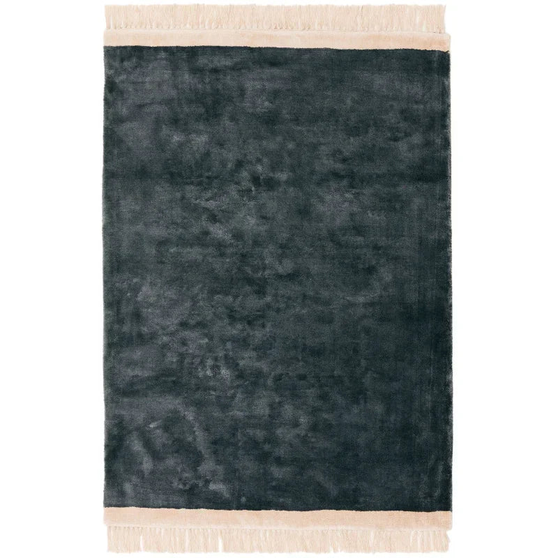 Dark grey area rug with cream fringed edges, soft texture, rectangular shape