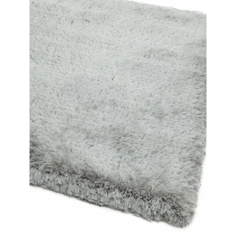 Light grey shaggy rug with soft plush pile and textured border detail