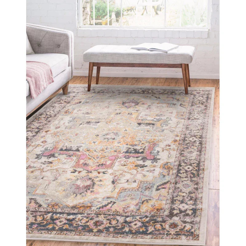 Patterned area rug with muted colors in modern living room with sofa and wooden bench