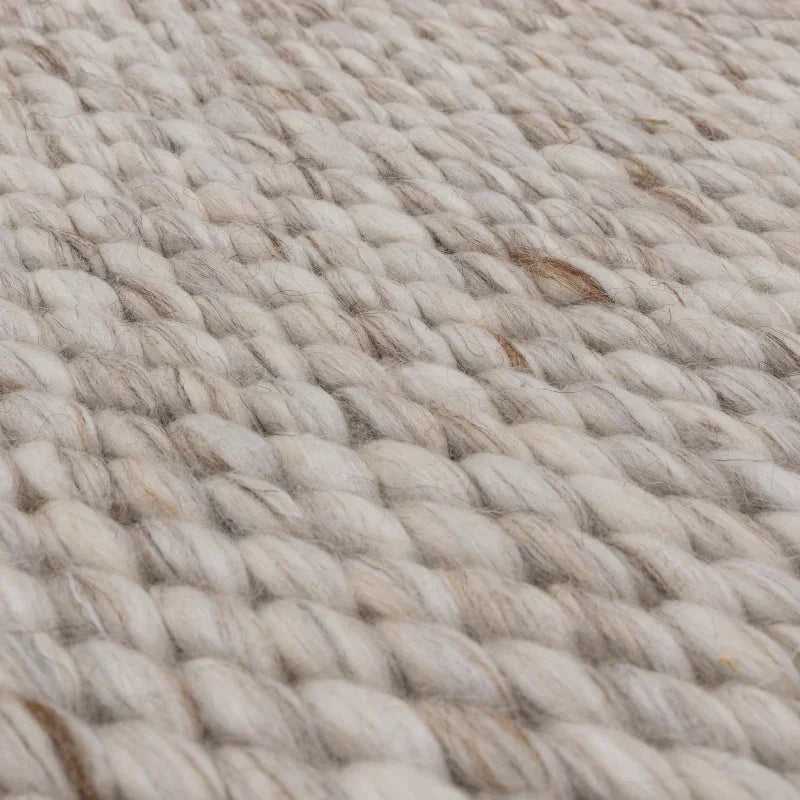Closeup of chunky wool rug in neutral tones showing thick woven texture