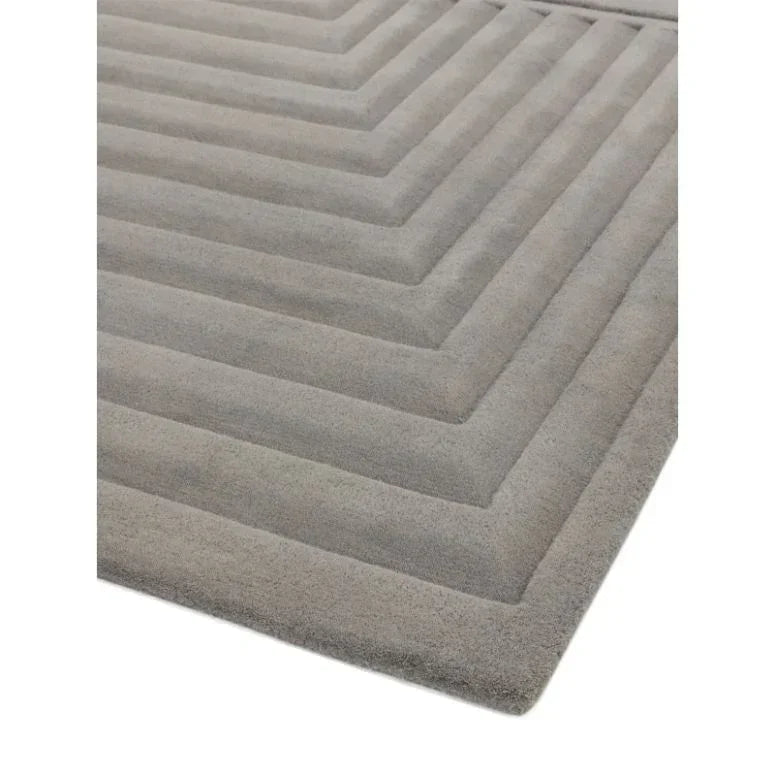 Grey geometric rug with raised textured lines and soft finish, corner angle view