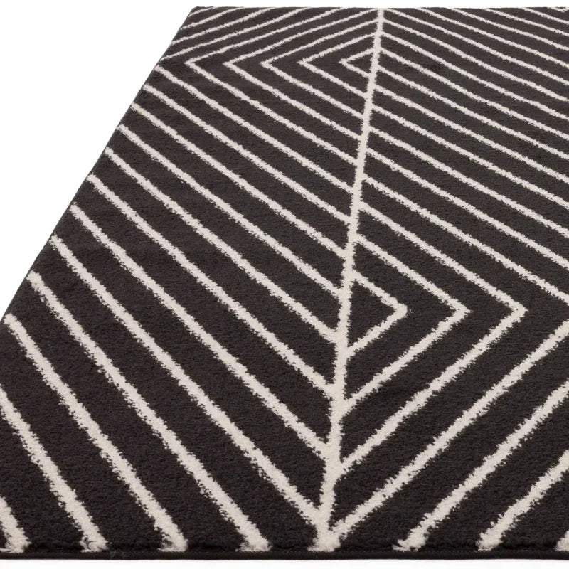 Black and white geometric rug with chevron pattern, close angle of textured surface