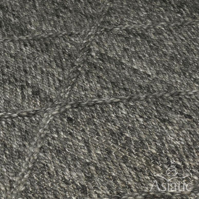 Close-up of grey wool rug with textured diamond pattern detail