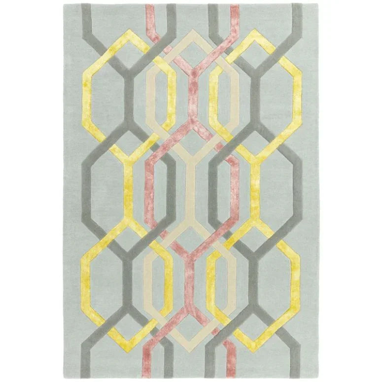 Geometric pattern area rug with yellow, pink, and grey interlocking shapes on a pale background