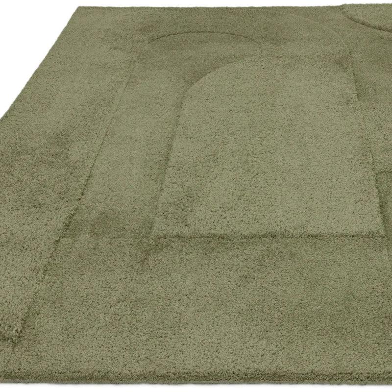 Green area rug with modern embossed geometric patterns and soft textured surface