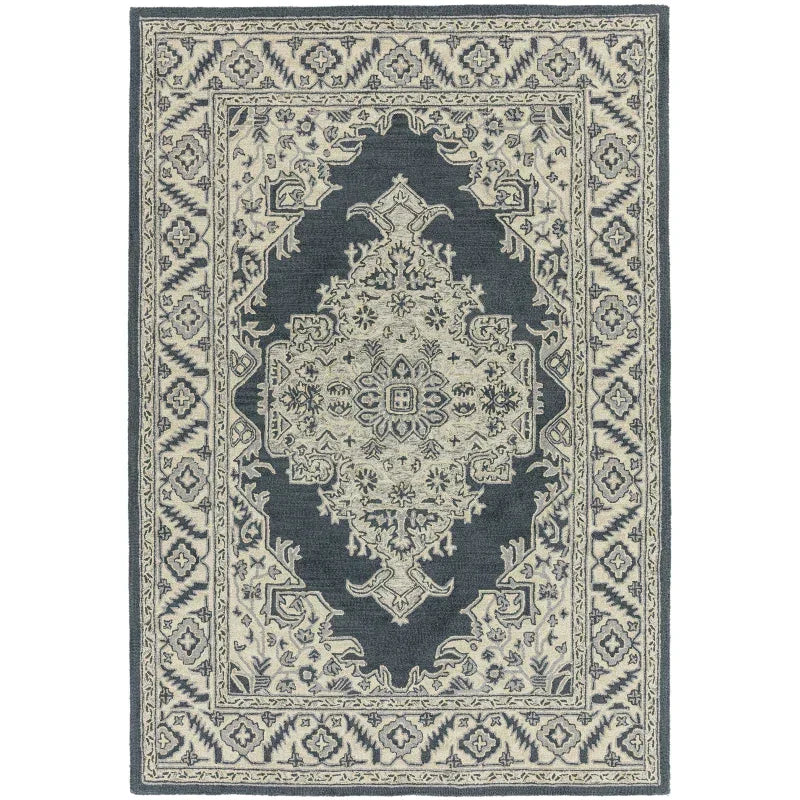 Traditional blue and cream patterned area rug with intricate border design