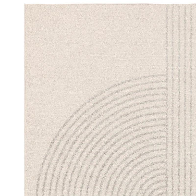 cream area rug with raised arc and line pattern in modern geometric design