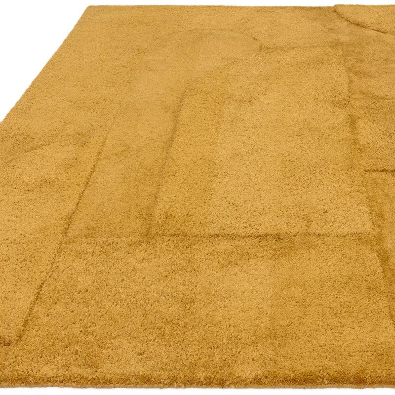 Gold shaggy rug with geometric carved pattern and soft textured surface