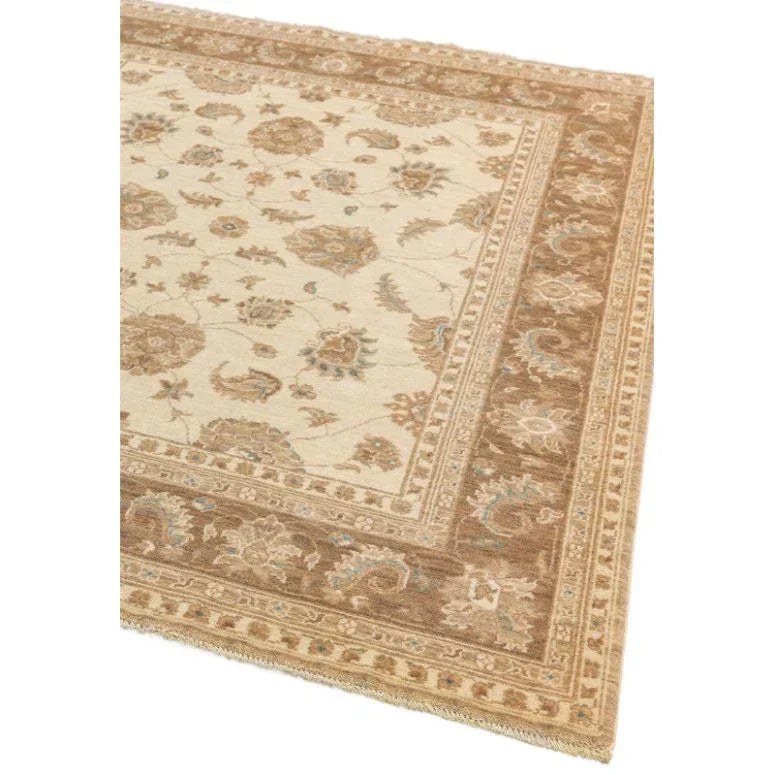 Beige and brown patterned area rug with floral border detail