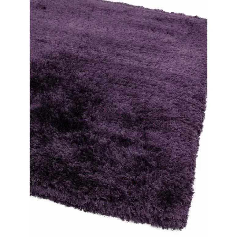 Plush purple shaggy rug corner close-up showing soft textured pile