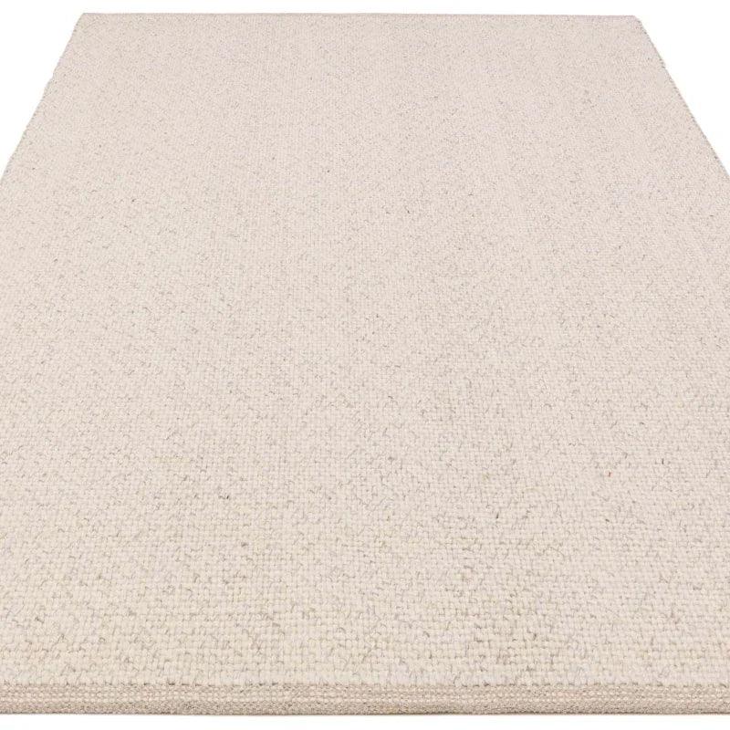 Rectangular cream wool rug with textured weave and clean finished edges