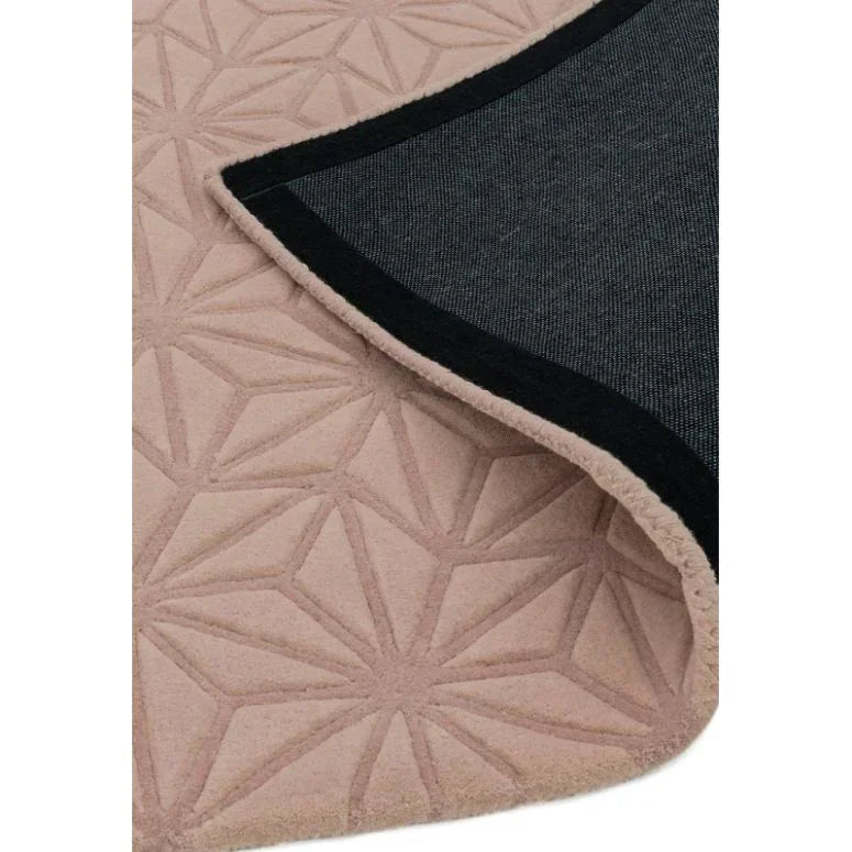 Beige geometric pattern rug with black non-slip backing, close-up of corner detail