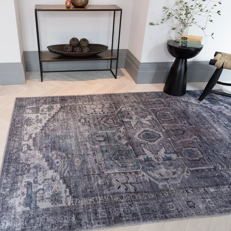 Grey patterned rug in modern living room with console table and decorative accents