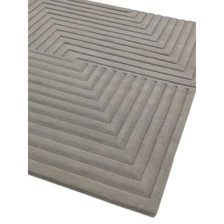 Grey geometric pattern rug with textured lines, corner view showing raised details