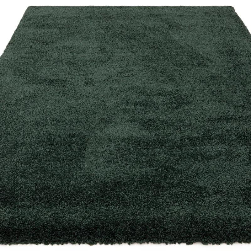 Dark green shaggy rug with a thick pile, close-up view showing plush texture