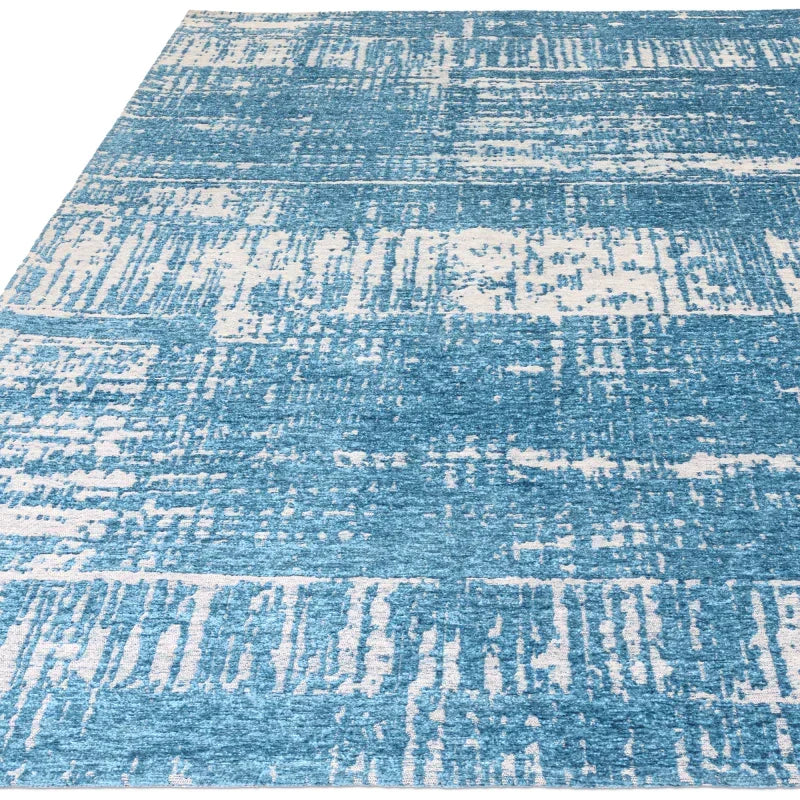 Blue and white abstract area rug with textured pattern
