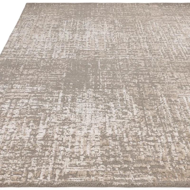 Beige and cream abstract pattern area rug with textured surface