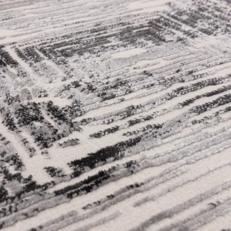 Close-up of grey and white abstract patterned rug texture