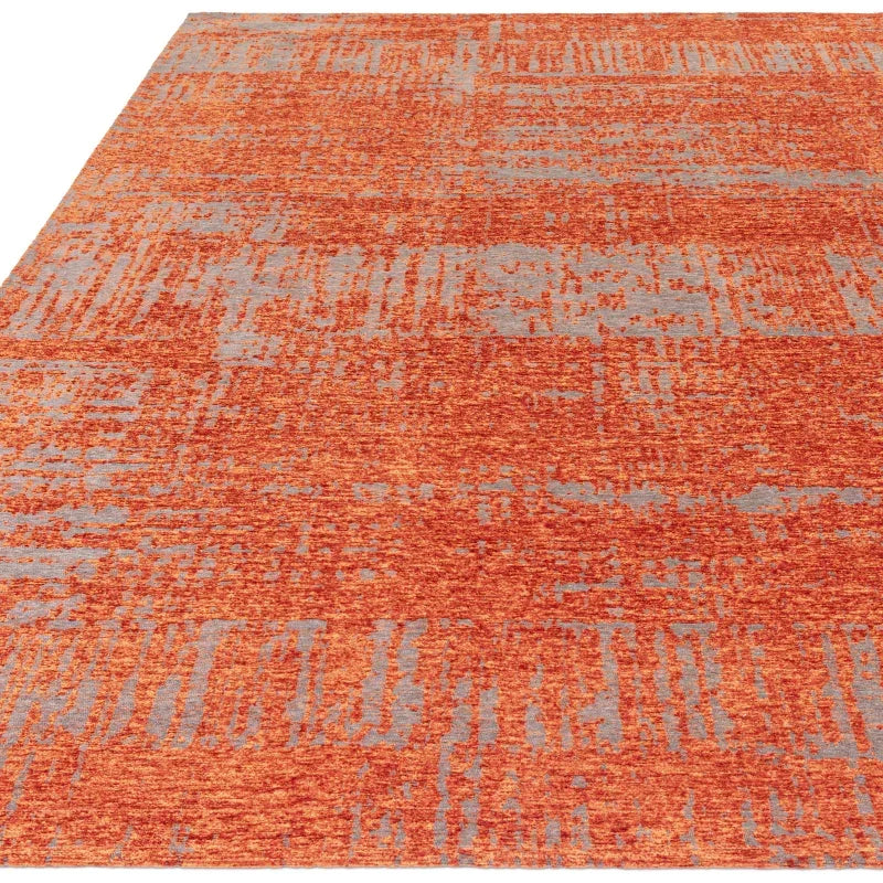 Orange and grey area rug with textured abstract pattern