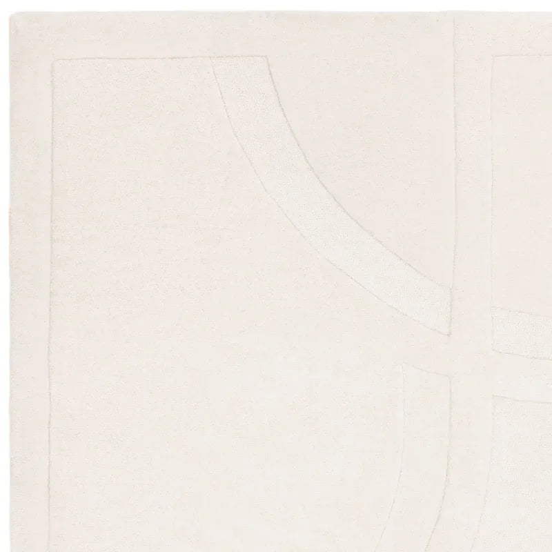 Ivory wool rug corner with subtle geometric line design and raised textured pattern