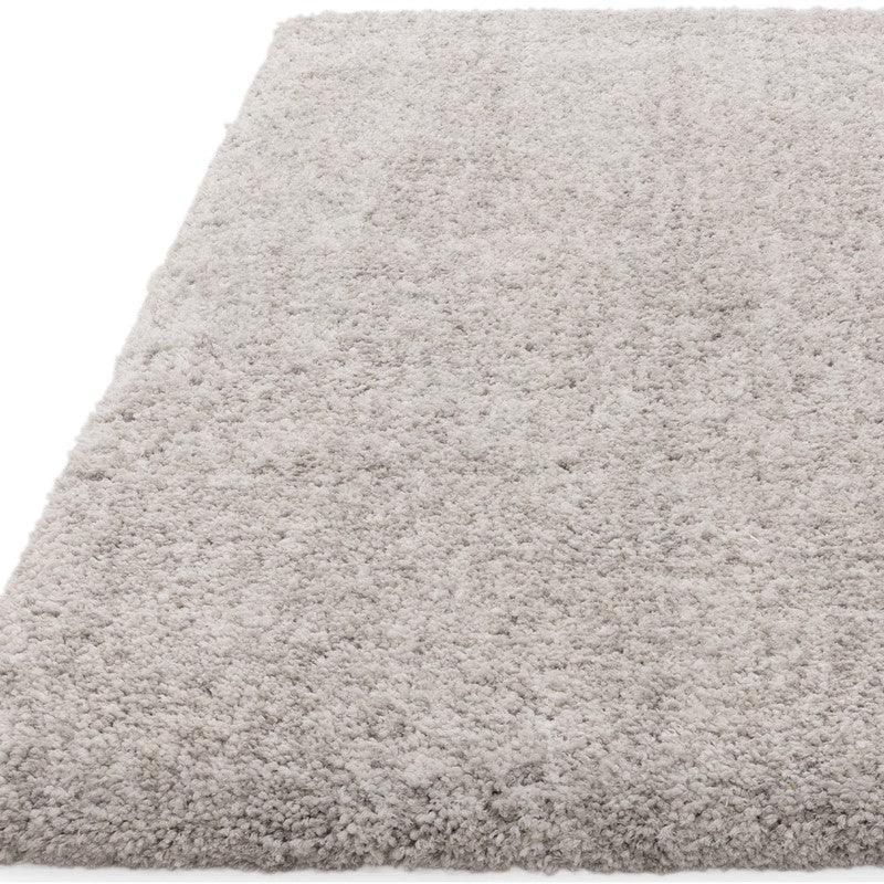 Light grey shaggy rug with soft pile and textured surface