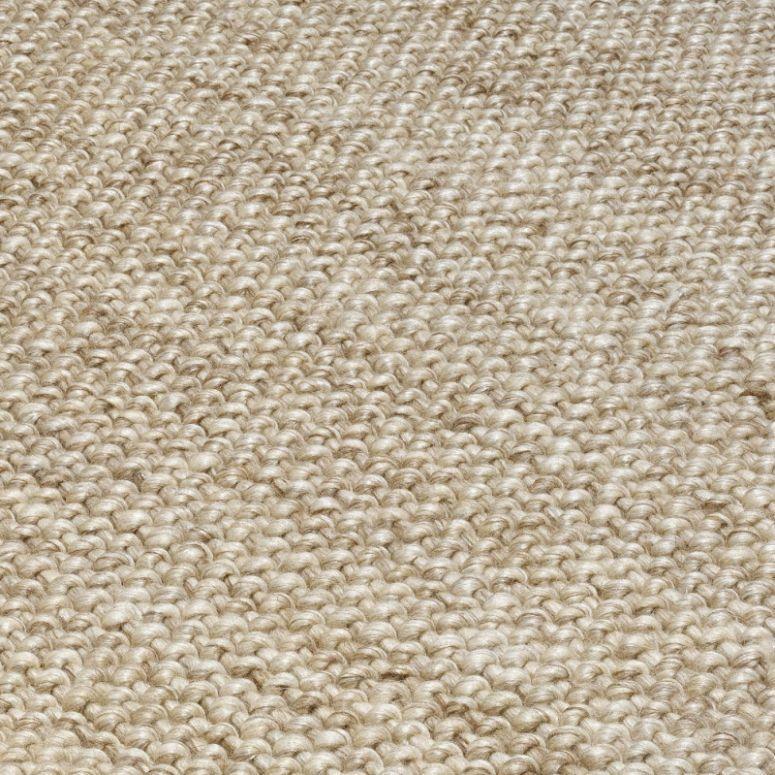 Beige woven wool rug texture close up