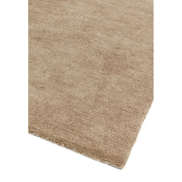 Beige area rug with soft texture and clean edge corner on white background