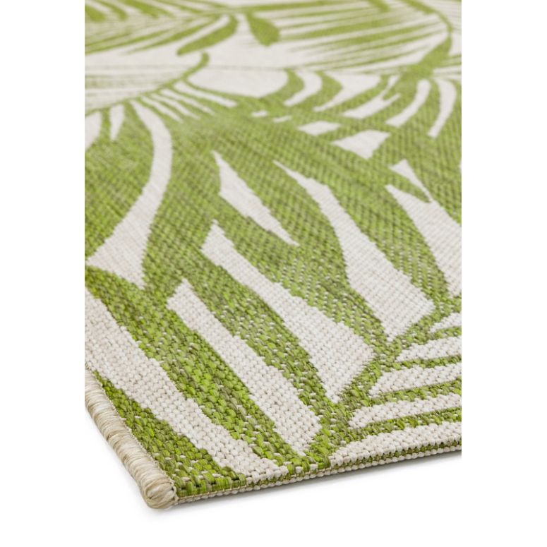 Green leaf pattern area rug with flatweave texture, close-up of corner detail